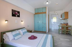 a bedroom with a bed with a hat on it at Sunrise Apartments Crete in Sfakaki