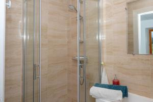 a shower with a glass door in a bathroom at Chez Pierre et Germaine in Saint-Maurice-de-Rotherens +12 photos