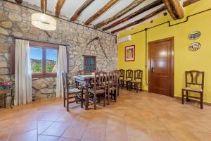 a dining room with a table and chairs at Mas de Sisco in Flix