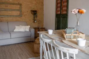 a living room with a couch and a table with chairs at Il Nido in Buonconvento +22 photos