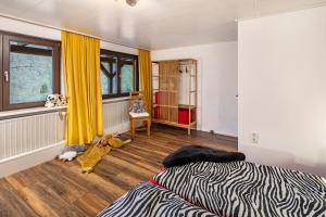 a bedroom with a zebra print bed and a window at Ferienwohnung Waldeckchen in Waldeck