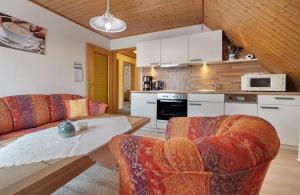 a living room with two couches and a table in a kitchen at Haus Stoldt in Meldorf