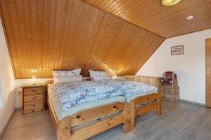 a bed in a room with a wooden ceiling at Haus Stoldt in Meldorf