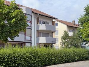 an apartment building with balconies on the side of a street at Geräumige schöne Ferienwohnung in Weingarten