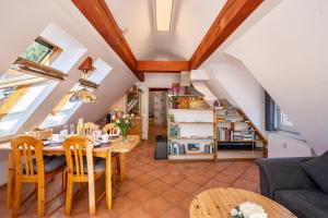 a kitchen and living room with a table and chairs at Schwarzwaldnest in Bad Wildbad