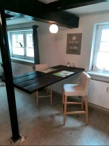 a dining room with a table and a chair at Abendsonne in Wurster Nordseeküste +8 photos