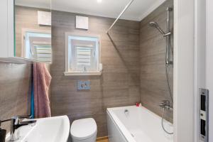 a bathroom with a tub and a toilet and a sink at Madera Concordiasee in Friedrichsaue +17 photos