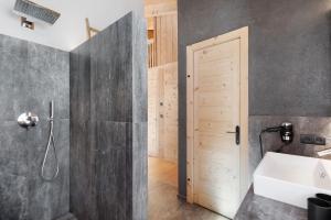 a bathroom with a shower and a sink at Chalet Berg in Selva dei Molini +37 photos