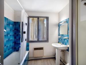 a bathroom with blue tiles and a sink and a shower at Chalet Lilette in Font-Romeu-Odeillo-Via +23 photos