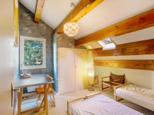 a bedroom with a bed and a desk and a sink at Chalet Lilette in Font-Romeu-Odeillo-Via