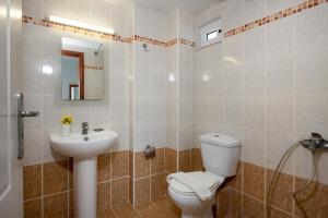 a bathroom with a toilet and a sink at Sunrise Apartments Crete in Sfakaki +38 photos