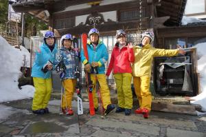 a group of people posing for a picture in the snow at Yonagoya in Kami