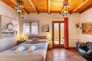 a bedroom with two beds in a room with wooden ceilings at La lechuga azul in Güéjar-Sierra