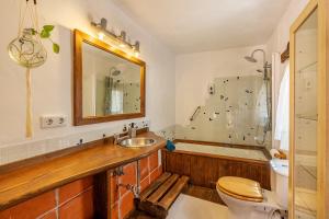 a bathroom with a sink and a toilet and a tub at La lechuga azul in Güéjar-Sierra +31 photos