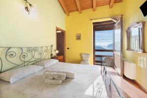 a bedroom with a bed with a view of the ocean at Agriturismo El Giardì in Marone