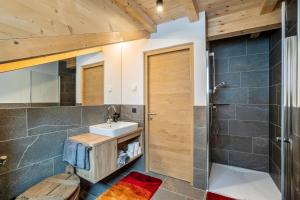a bathroom with a sink and a shower at Krämerhof Apt Villnösser Geisler in Rodengo +16 photos