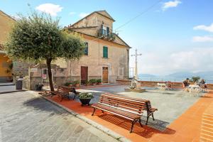a group of benches sitting in front of a building at Uliveto in Lerici