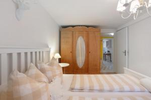 a bedroom with a bed and a wooden cabinet at Landhaus Dachsberg in Wittenschwand