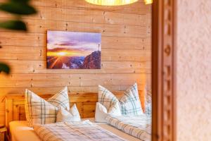 a bedroom with two beds in a wooden wall at Ferienwohnung Höllental in Grainau