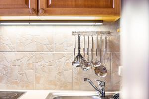 a kitchen with utensils hanging on a wall at Ferienwohnung Höllental in Grainau +22 photos