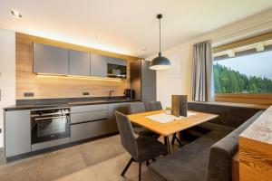 a kitchen and living room with a table and a couch at Oberhaushof in Santa Valpurga