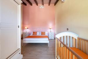 a bedroom with a bed with orange and white sheets at Casa Sole in Dorgali