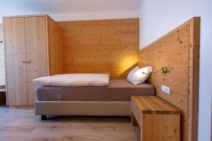 a bedroom with a bed in a wooden wall at Gass Apartment A in Laion
