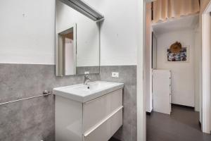 a bathroom with a white sink and a mirror at La terrazza di via Daneri 2 in Bonassola +25 photos