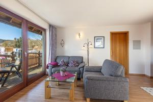 a living room with two chairs and a table at Appartmenthaus Felicitas in Willingen
