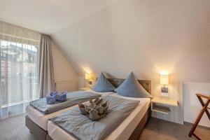 a bedroom with a large bed with blue pillows at Appartmenthaus Felicitas in Willingen