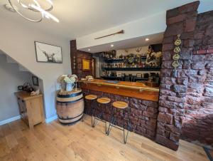 a bar in a restaurant with a brick wall at 3 Bed in Egremont oc-90050 in Hale