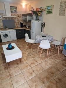 a kitchen with a table and chairs and a refrigerator at Gite l'Embellido in Mouriès +7 photos