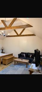 a living room with a couch and a table at Ystrad Fach Farm in Llangendeirne