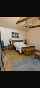 a bedroom with a bed and a bench in it at Ystrad Fach Farm in Llangendeirne