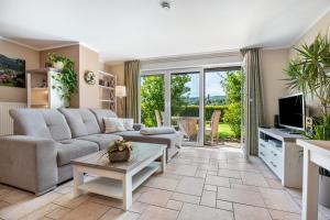 a living room with a couch and a tv at Ferienwohnung Fasse in Uslar