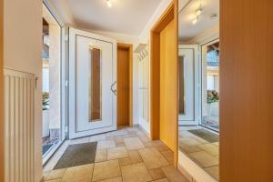 a hallway with orange walls and a door with a mirror at Ferienwohnung Fasse in Uslar +24 photos