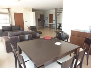 a living room with a table and a couch at Villa Halcyon Caboverde in Cidade Velha