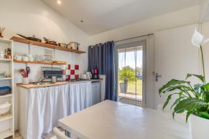 a kitchen with a sink and a counter top at Mas des Cypres - Mazet 7 in Saintes-Maries-de-la-Mer