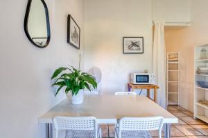 a dining room with a table and chairs and a mirror at Mas des Cypres - Mazet 7 in Saintes-Maries-de-la-Mer +15 photos