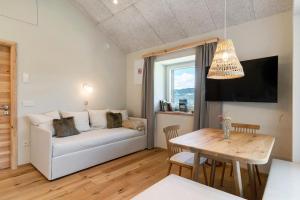 a living room with a couch and a table at Höllerhof in Cornedo all'Isarco