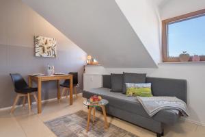 a living room with a couch and a table at Bergchalet Mirabell - Hofgut in Friedrichshafen