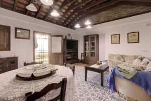 a living room with a table and a couch at Casa Jimena 2 personas in Jimena de la Frontera