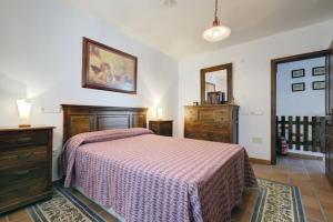 a bedroom with a bed and a dresser and a mirror at Casa Jimena 2 personas in Jimena de la Frontera +21 photos