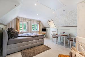 a living room with a couch and a dining room at My Little Rose Cottage in Dörpling