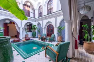 a courtyard with a pool in a building at Riad Lalla Azalay in Marrakesh