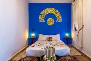 a blue room with a bed and a blue wall at Riad Lalla Azalay in Marrakesh +22 photos