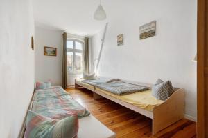 a room with two beds and a window at Alte Seifensiederei - Ferienloft in Stralsund