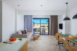 a kitchen and living room with a couch and a table at Lambis Athina in Lindos