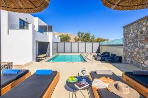 a villa with a swimming pool and a house at Lambis Athina in Lindos