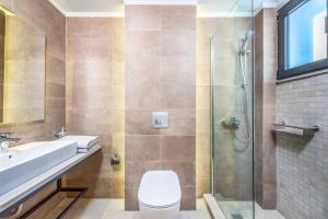 a bathroom with a toilet and a sink and a shower at Lambis Athina in Lindos +8 photos